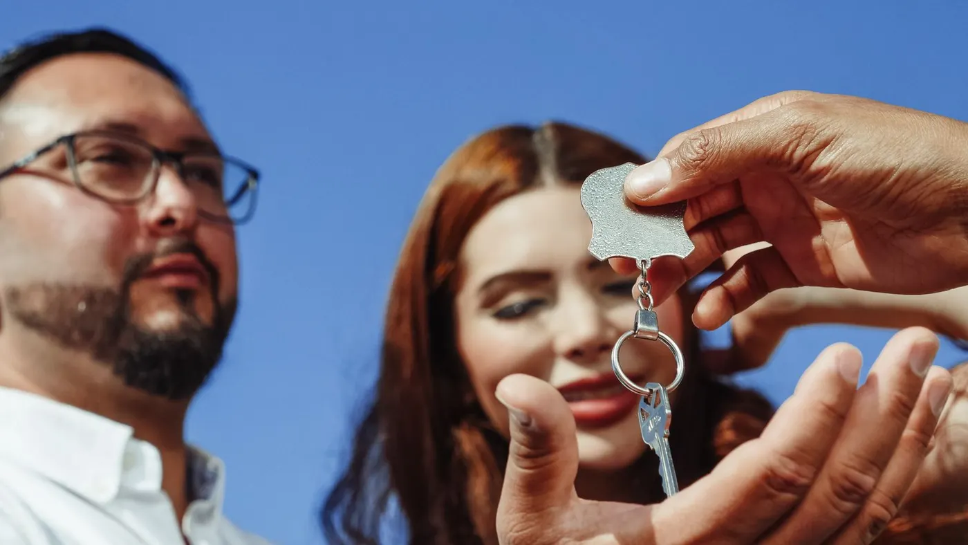 A couple being handed the keys to a property