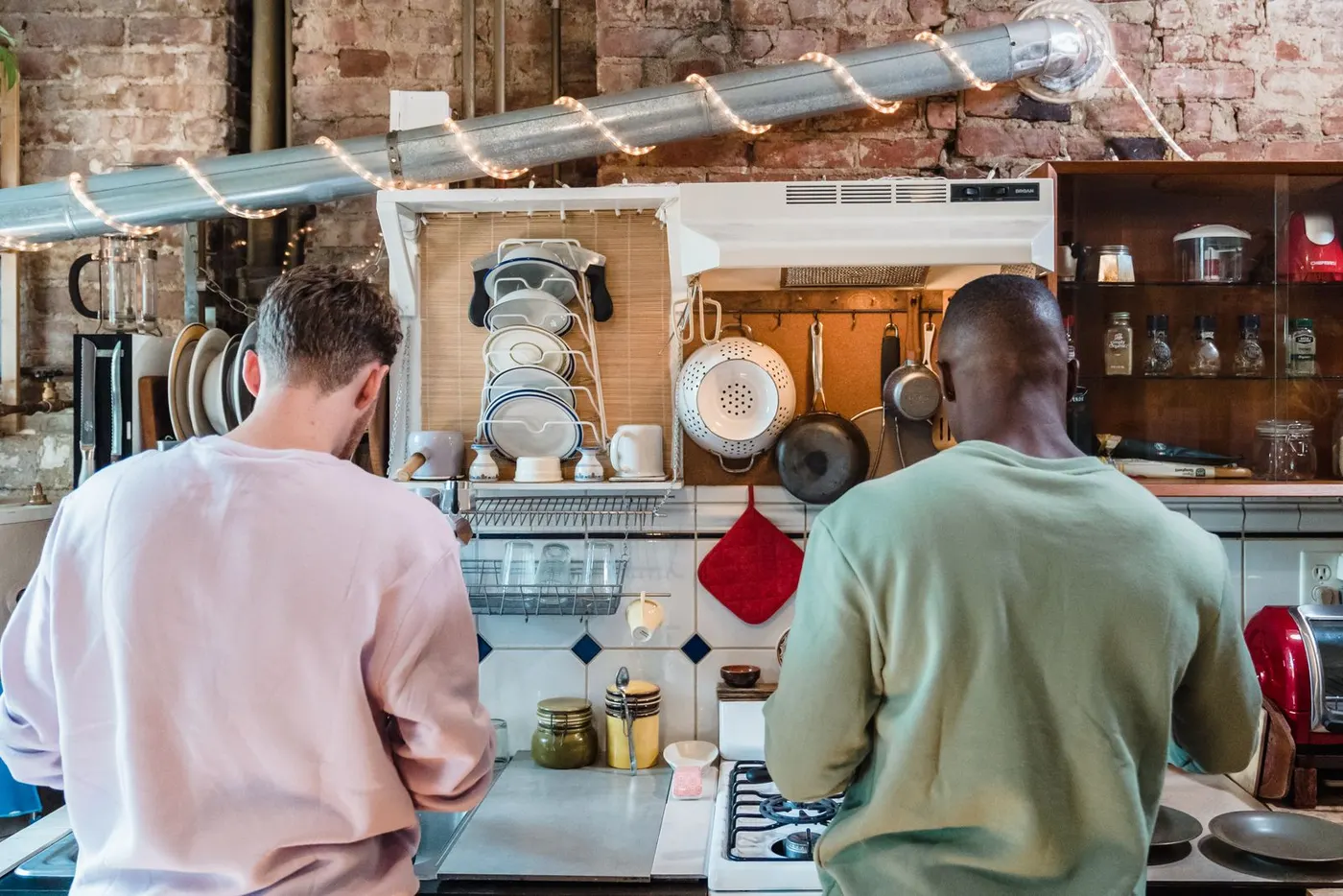 Two housemates cooking in a shared kitchen