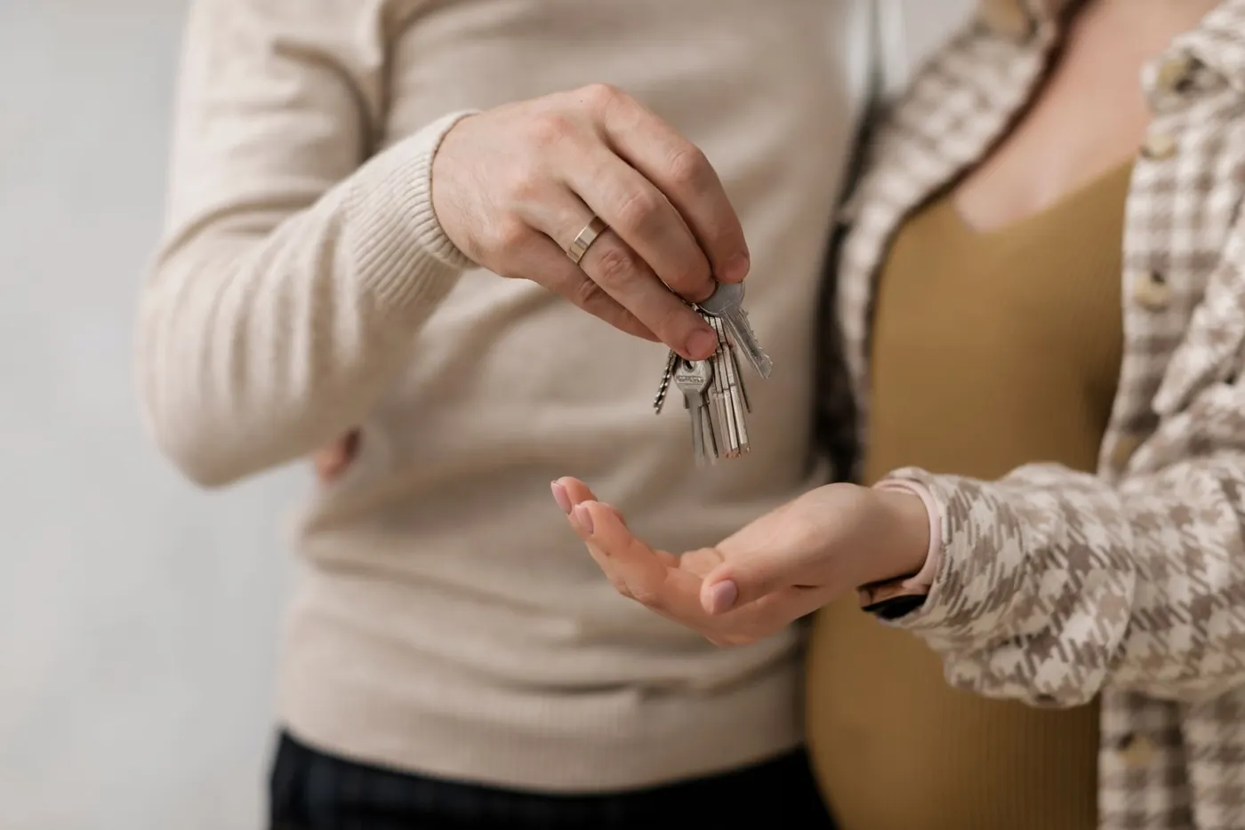 One person handing a set of keys to another