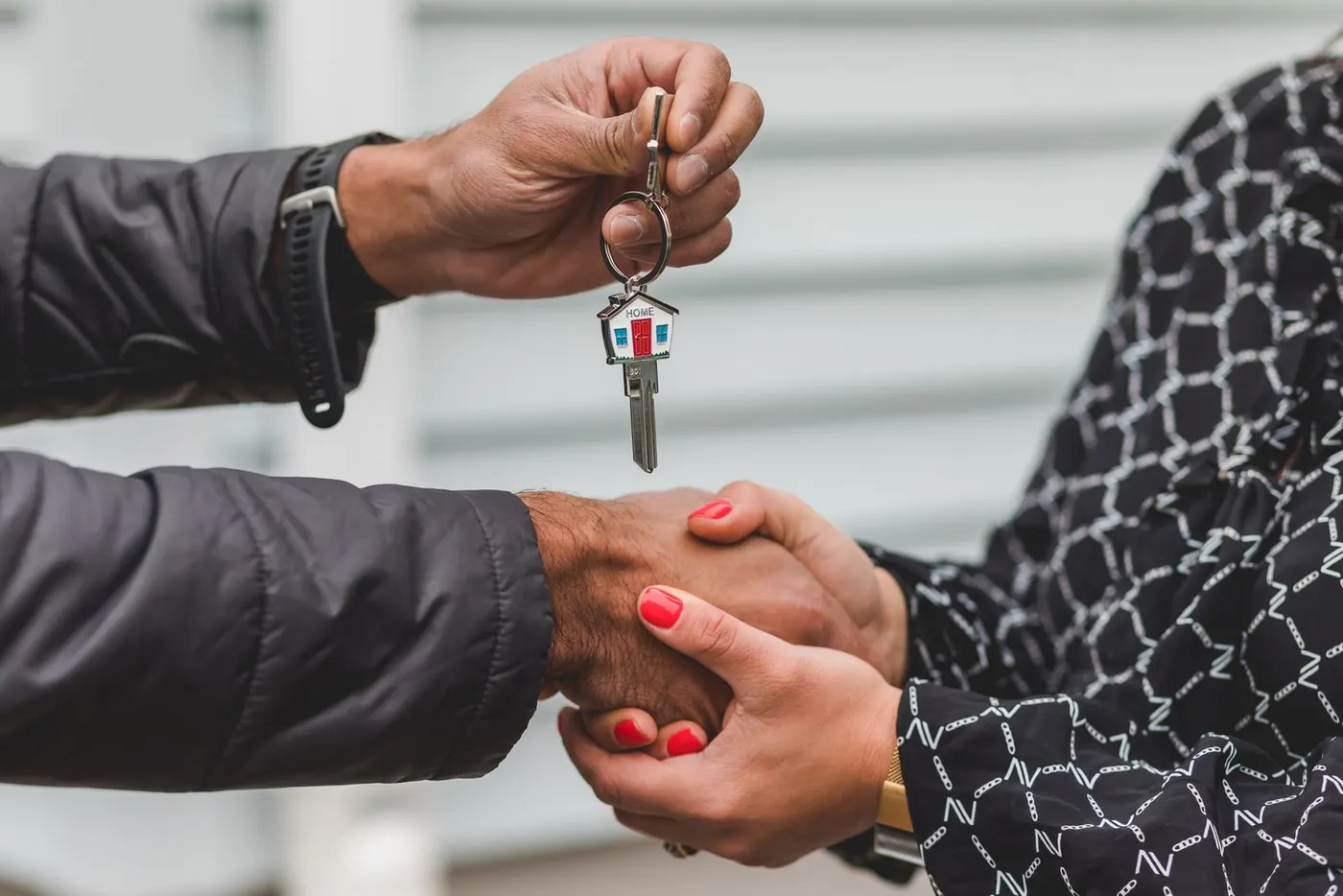 A handshake as a house key is handed over