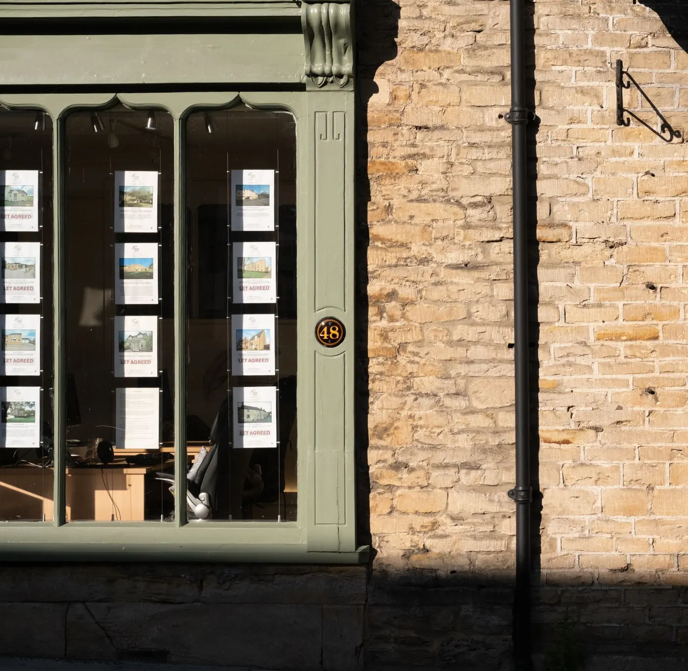 An estate agent's window with properties marked let agreed