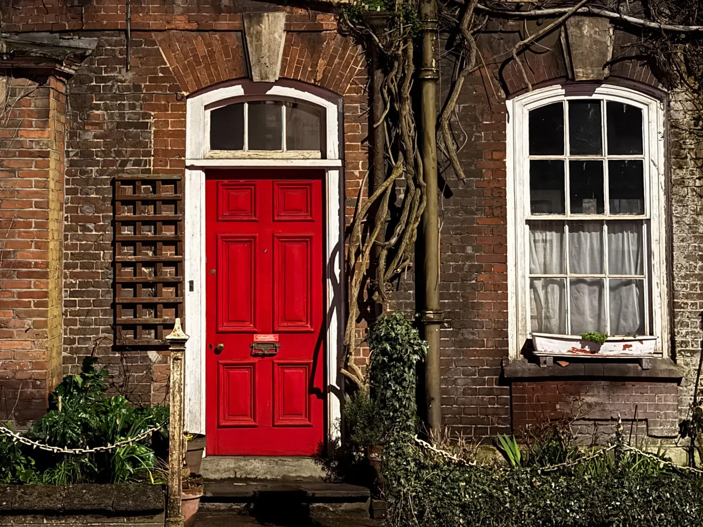 A red front door on a brick townhouse